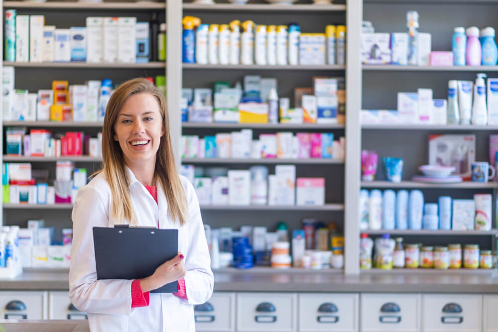 female pharmacist with clipboard in pharmacy
