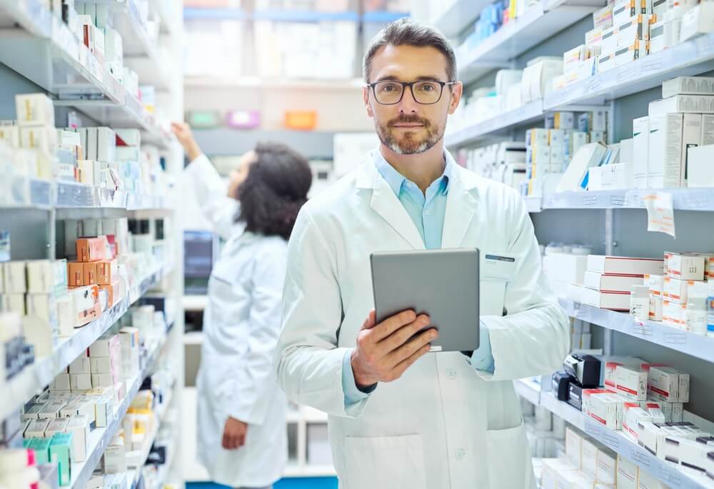 male pharmacist using tablet