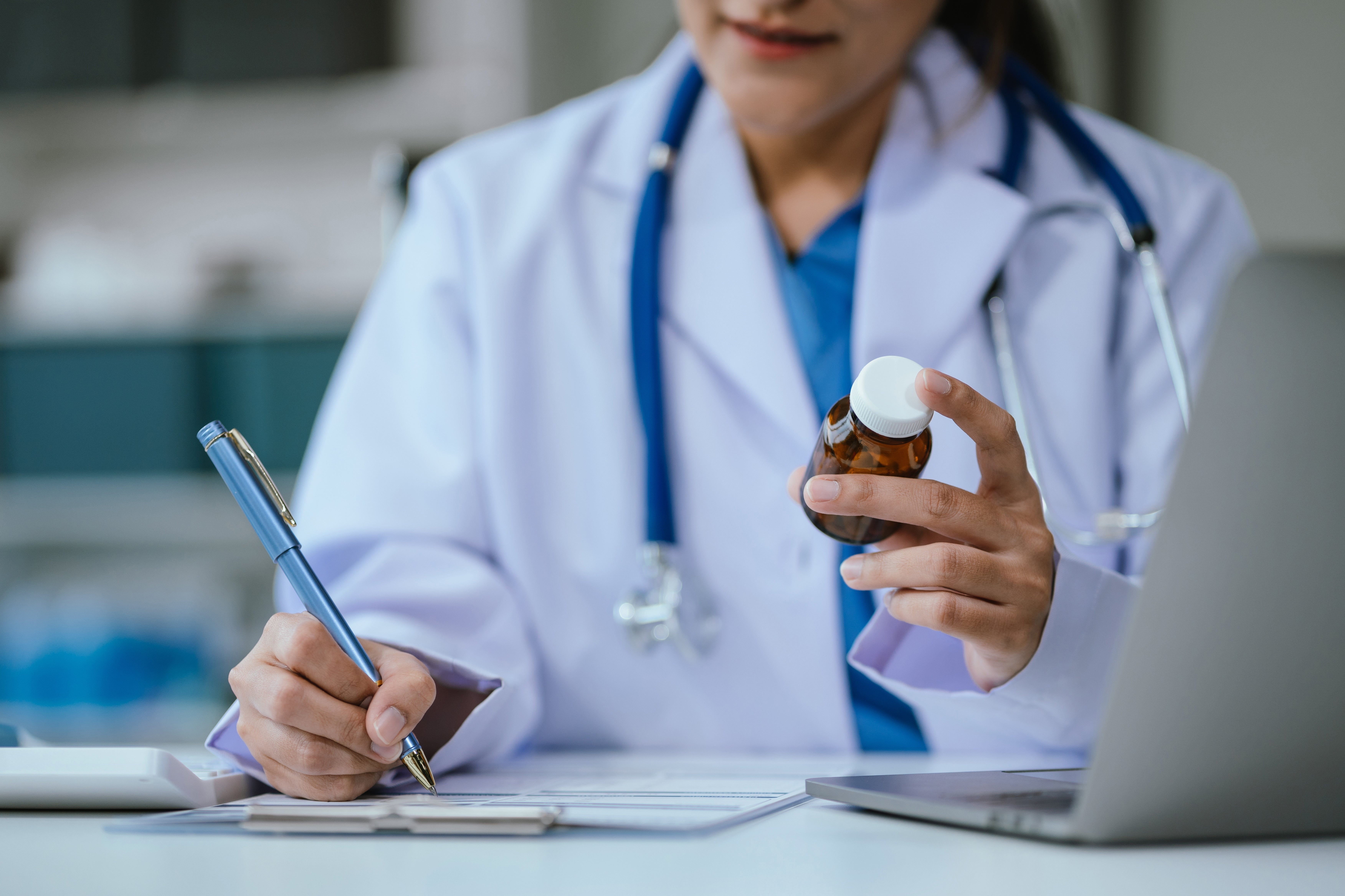 pharmacist writing prescription information