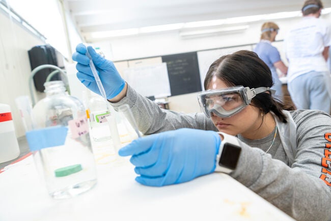 student with test tube during campus immersions