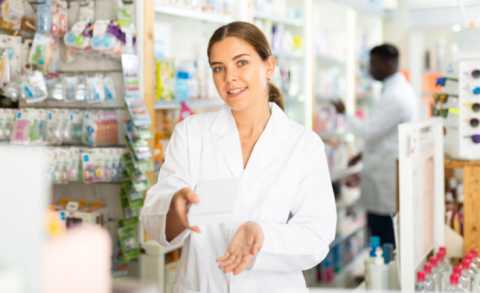 female pharmacist helping customer during national pharmacist month